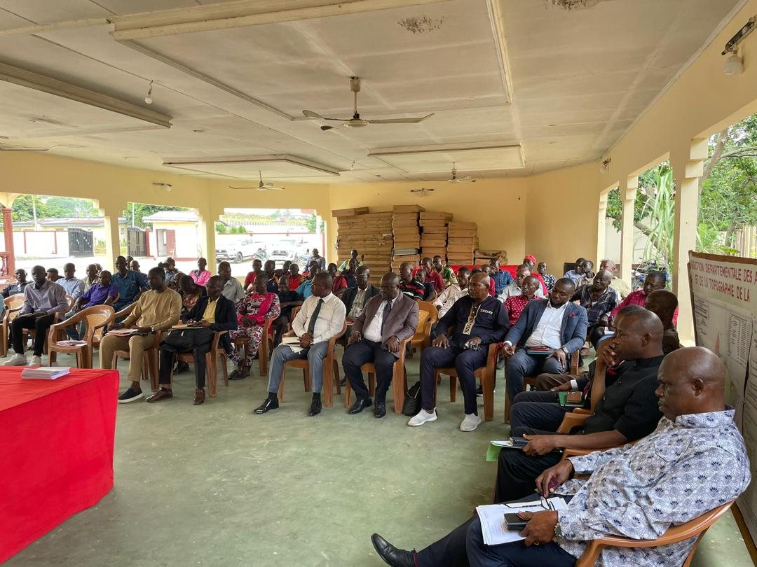 Participants seated in rows in a meeting hall at the Prefecture