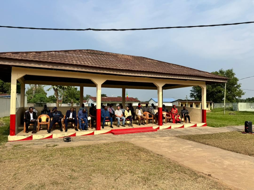 Officials and guests seated under a pavilion at the official launch of the road works